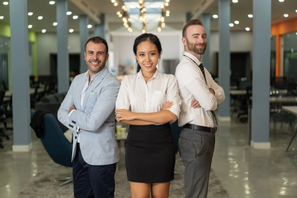 smiling-business-people-looking-camera-posing-office_1262-15199